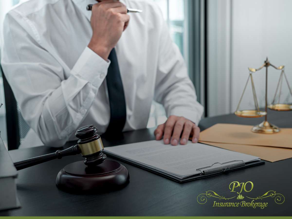 Lawyer reviewing documents with gavel and scales of justice on desk, symbolizing protection against legal issues after a cyber attack