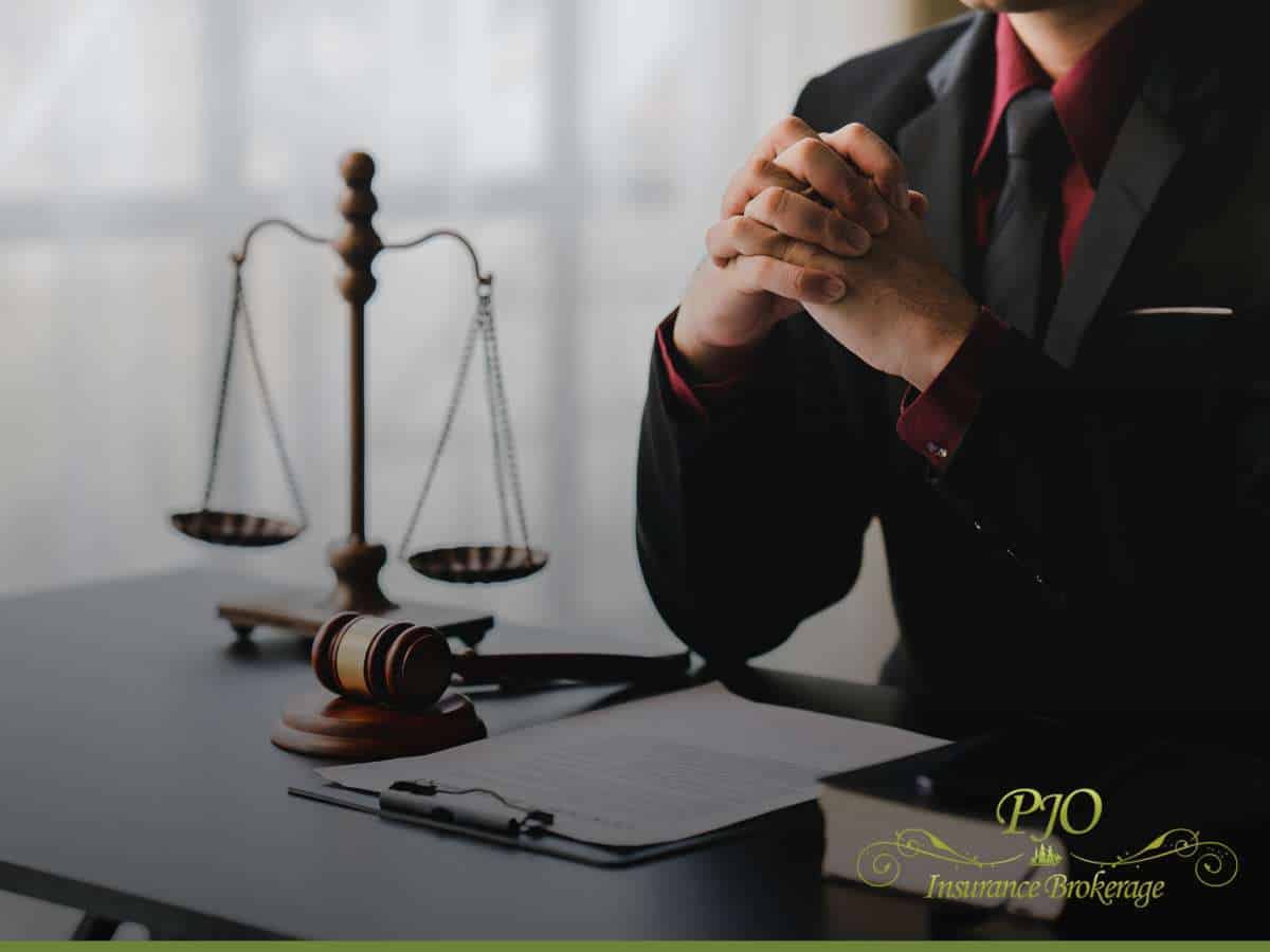 Independent Insurance Agent reviewing documents at desk with legal scale and gavel