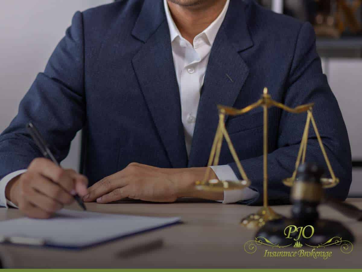 Business professional reviewing documents on Pollution Liability Insurance with legal scales and gavel on desk