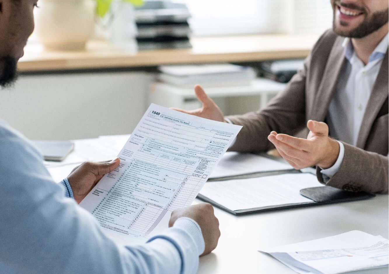 business-insurance-broker-meeting-with-a-scottsdale-landscaping-company Business insurance broker meeting with a Scottsdale landscaping company owner to review insurance coverage options, policy documents, and risk management solutions for landscaping businesses